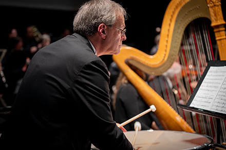 Dr. Matthew Springer playing timpani with an orchestra