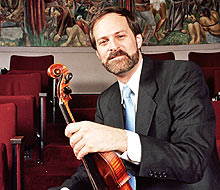 Dr. Matthew Springer holding his violin
